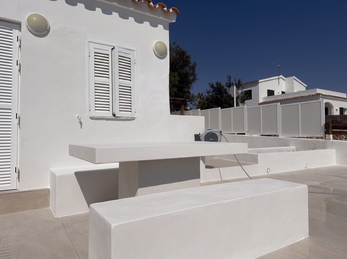 Table et banc maçonnés habillés de petit carrelage à l'entrée à Salgar